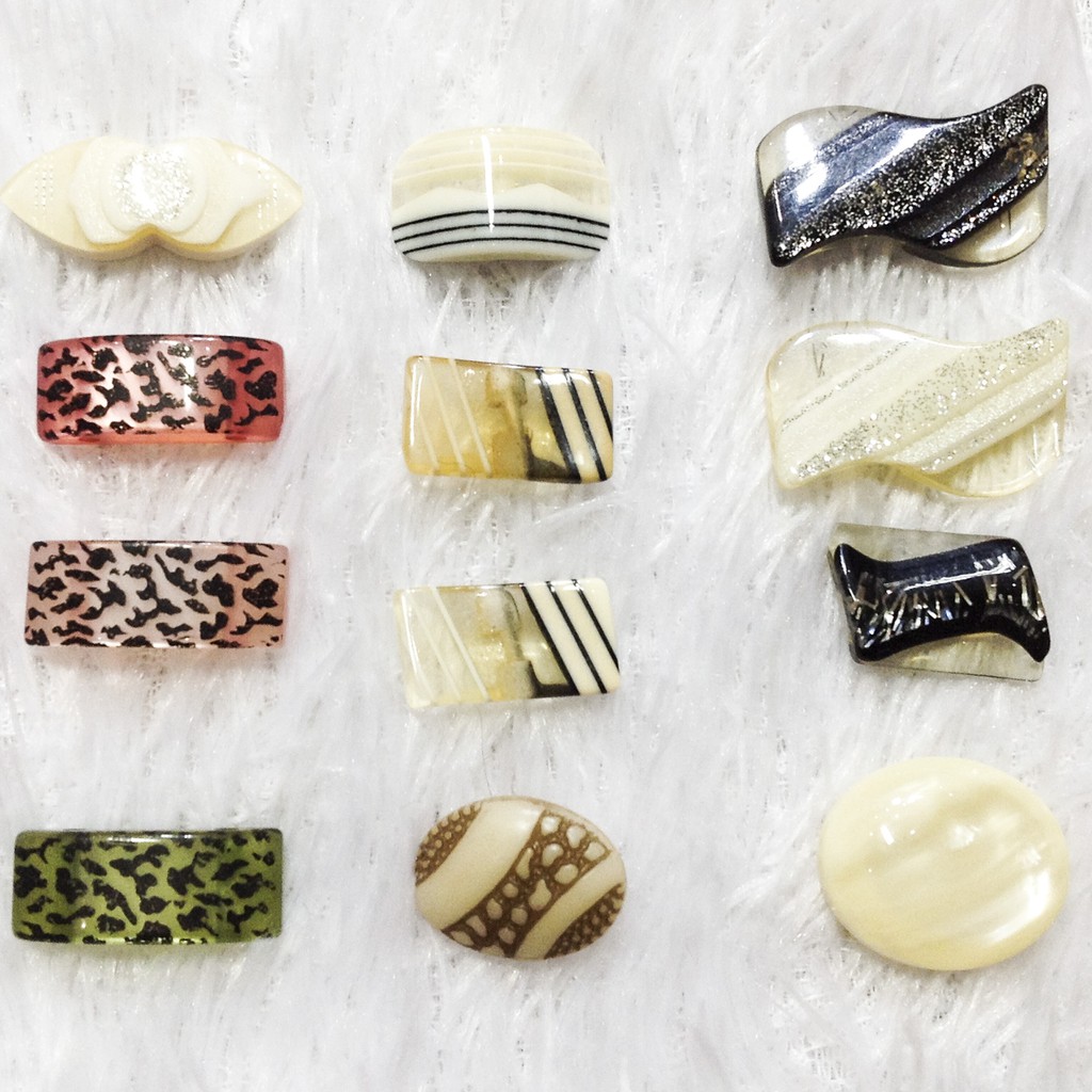 4 rectangular square buttons with printed button patterns attached to ...