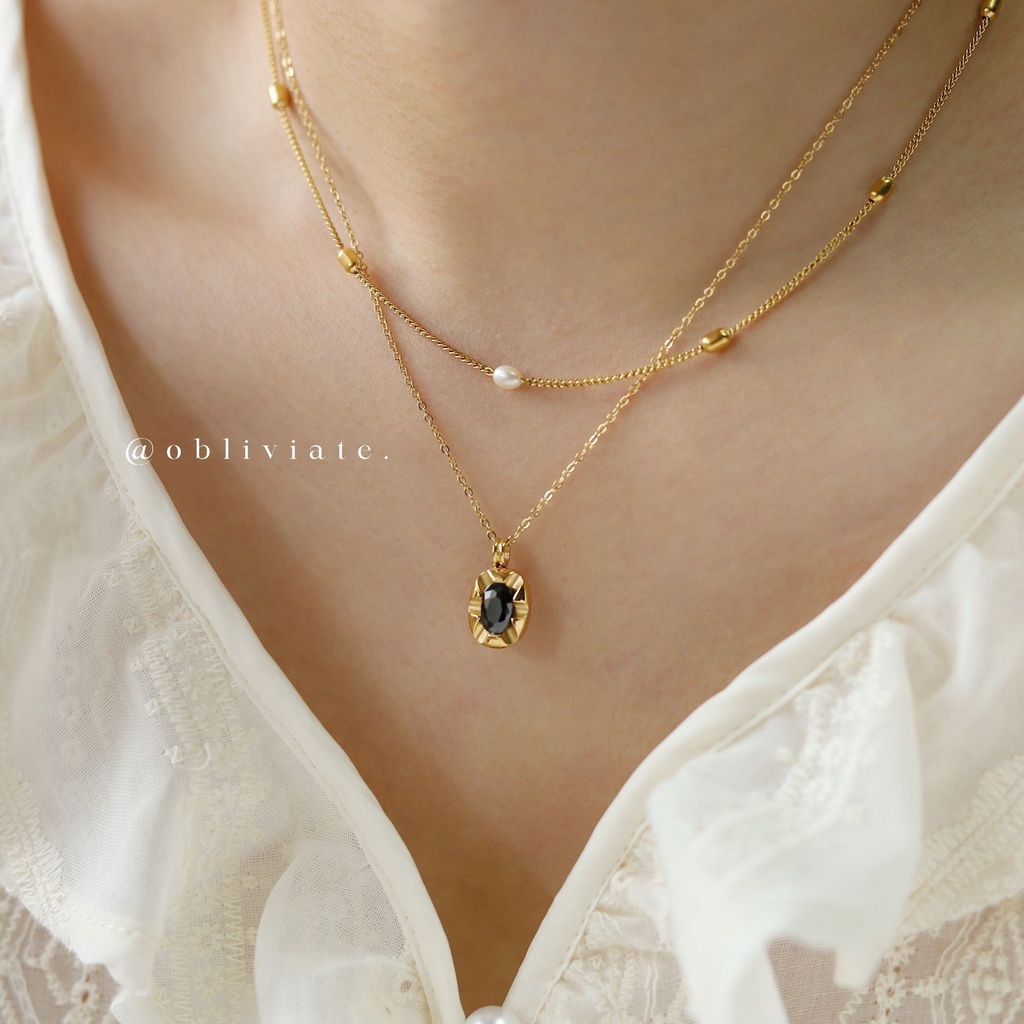 Gold necklace with sale black pendant