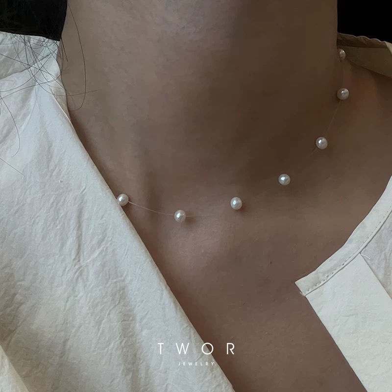 Gentle handmade invisible line with TWOR falling on the neckTWOR the ...