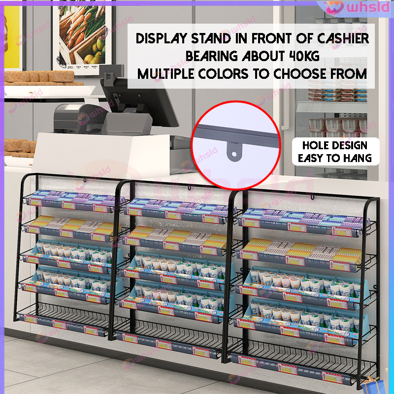 A small shelf shop snack rack is displayed in front of the cash ...