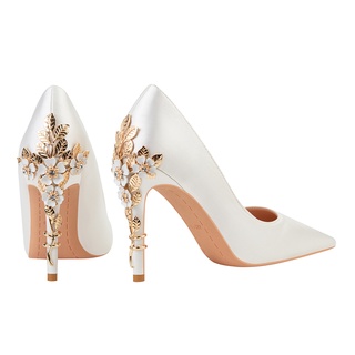 White pumps with 2025 gold heel