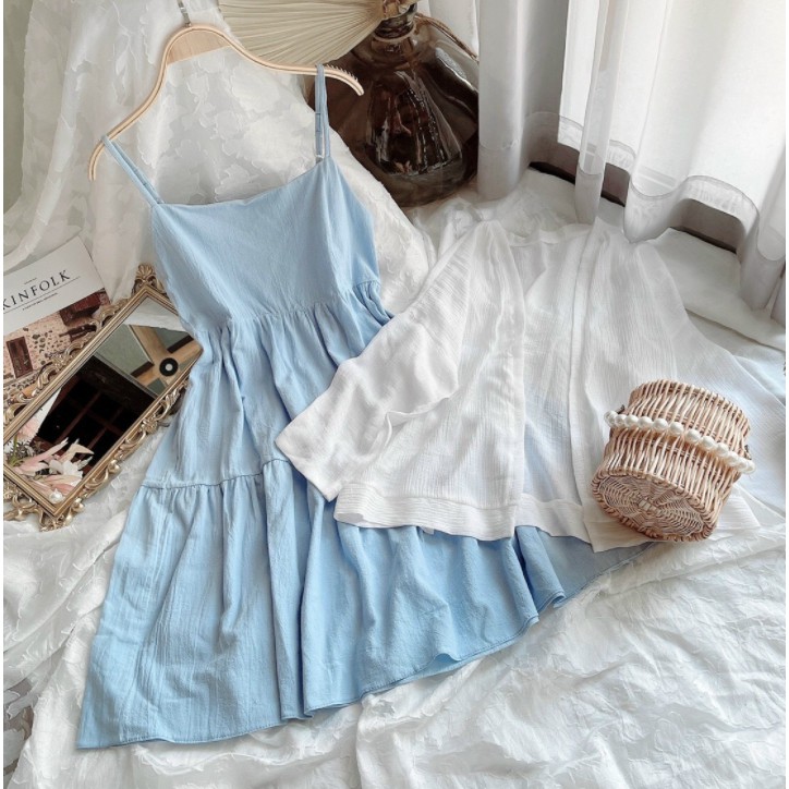 Blue dress shop with white cardigan