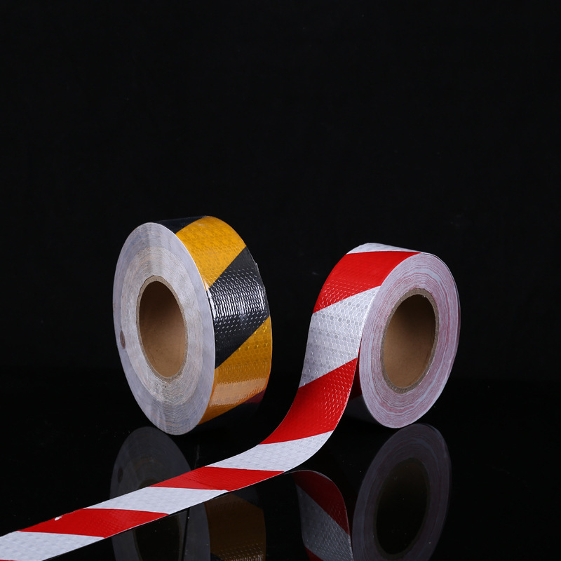 Reflective warning tape, shiny black and yellow diagonal strips ...