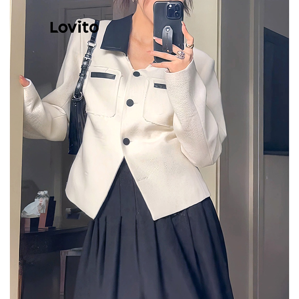 White blazer with 2025 black buttons