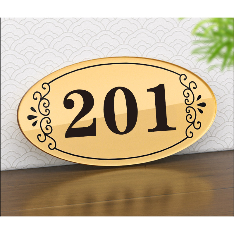 Oval shaped signboard with black lettering on a gold background unit ...
